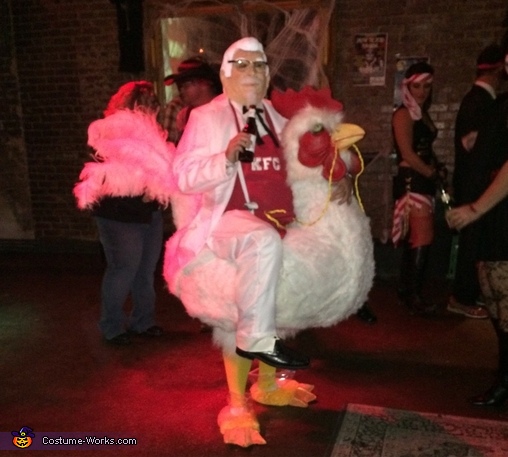Colonel Sanders riding a Chicken Costume