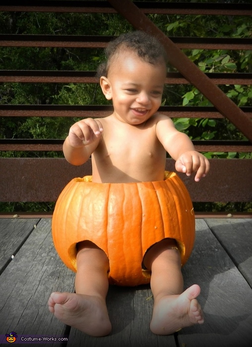Baby sitting in a Pumpkin Costume